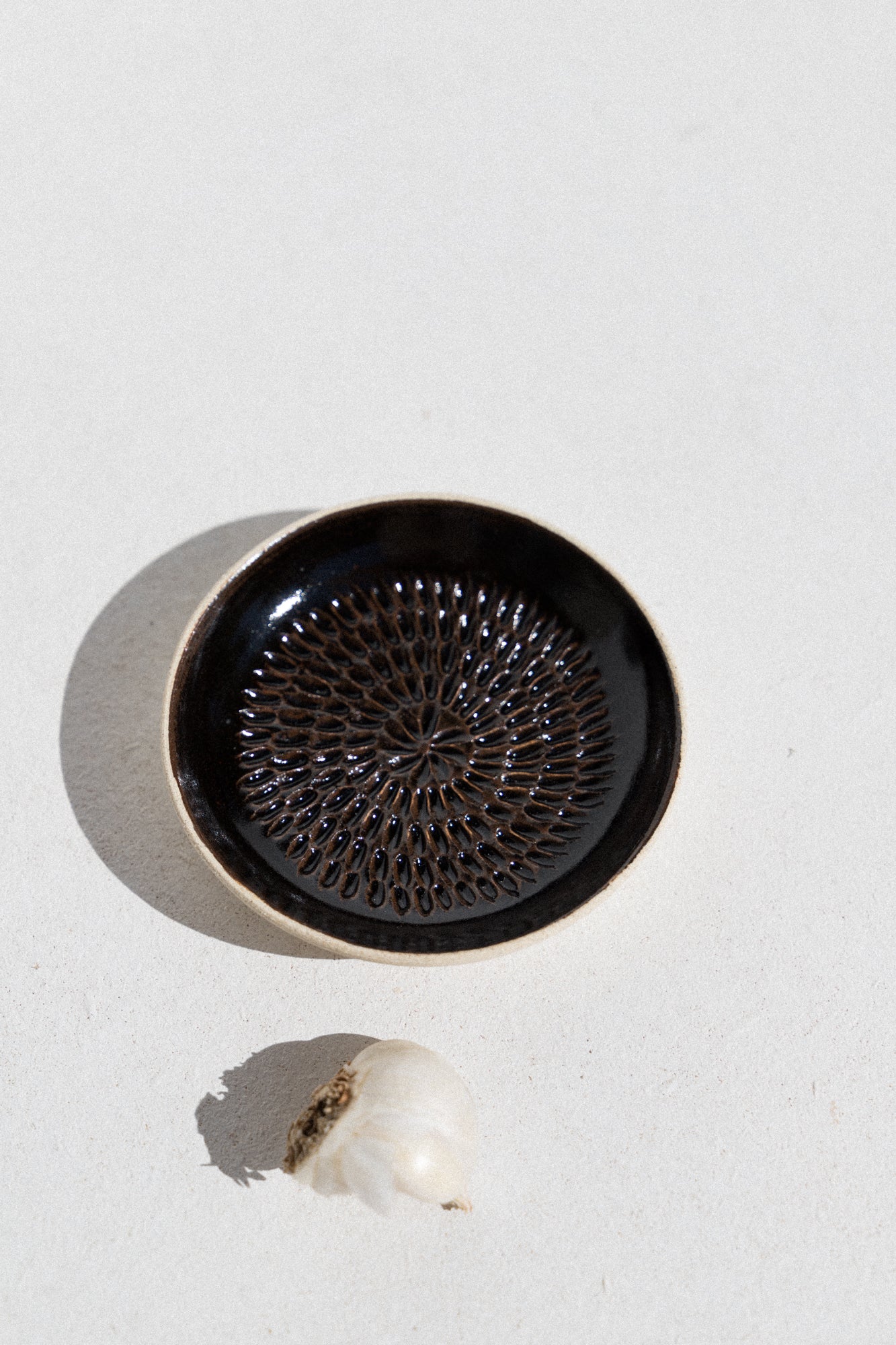 Kura studio ceramic garlic grater in black. From Maker's Mrkt Makers Market Melbourne